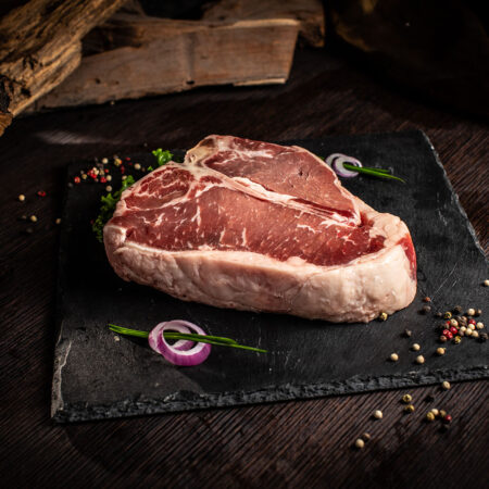 Raw Porter House photo of a 2" raw porter house steak
